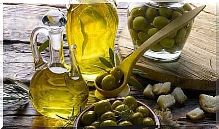 Olive oil and olives on a table