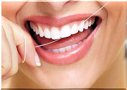 Woman using dental floss.