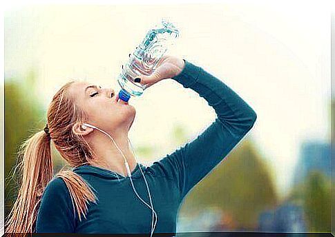 Girl drinking sports drink.