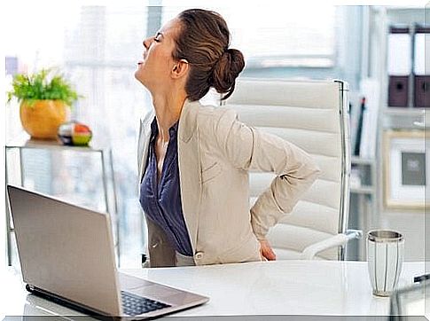 Woman at work with back pain