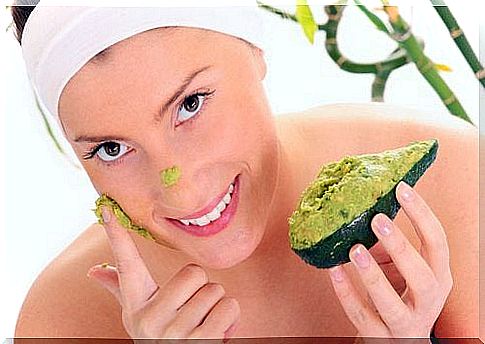 Woman smears avocado mask on face