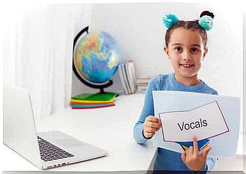 A girl pointing to a word.