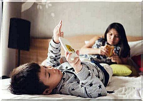 Two children staring at smartphones.