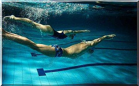 Two people swimming together