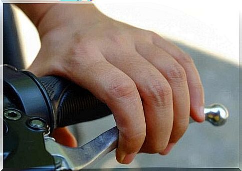 A person checking the brakes on a motorcycle.