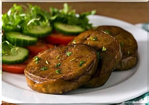 A plate of seitan steaks and vegetables.