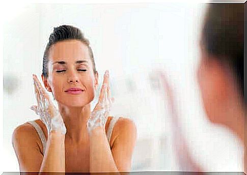 Woman cleanses face