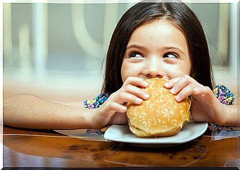 Girl eating burger.