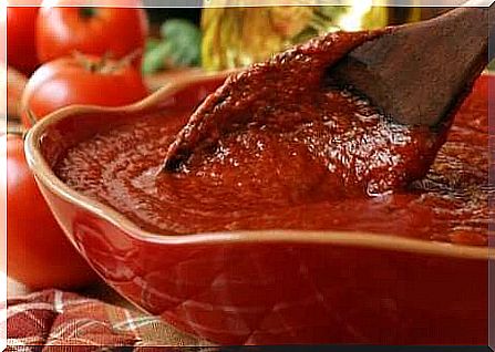 homemade tomato sauce with a wooden spoon