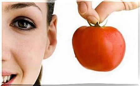 a woman holding a tomato